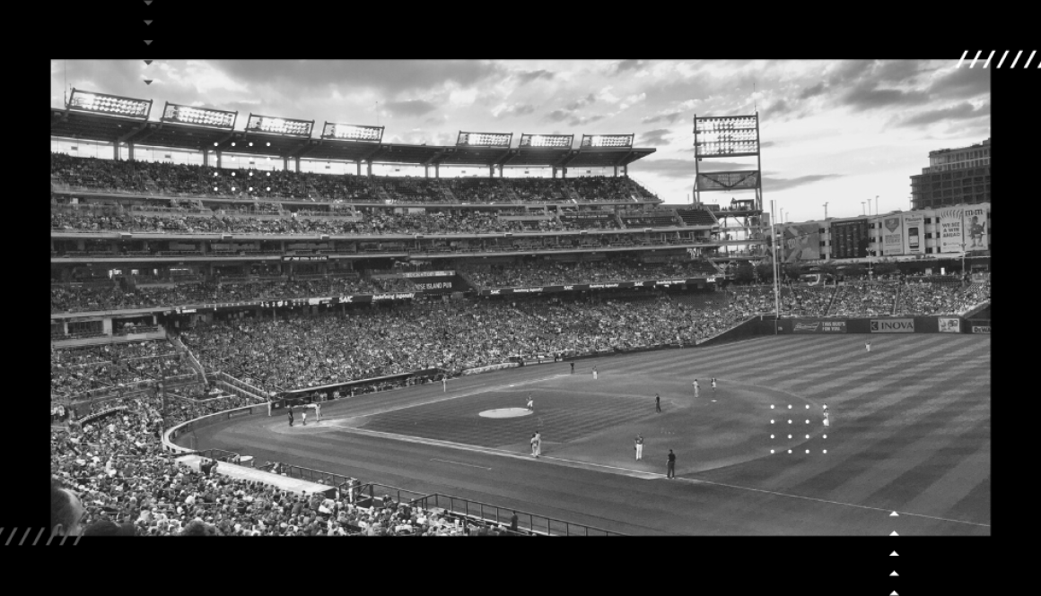 Empty baseball field full of fans.