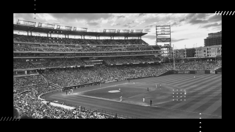 Empty baseball field full of fans.